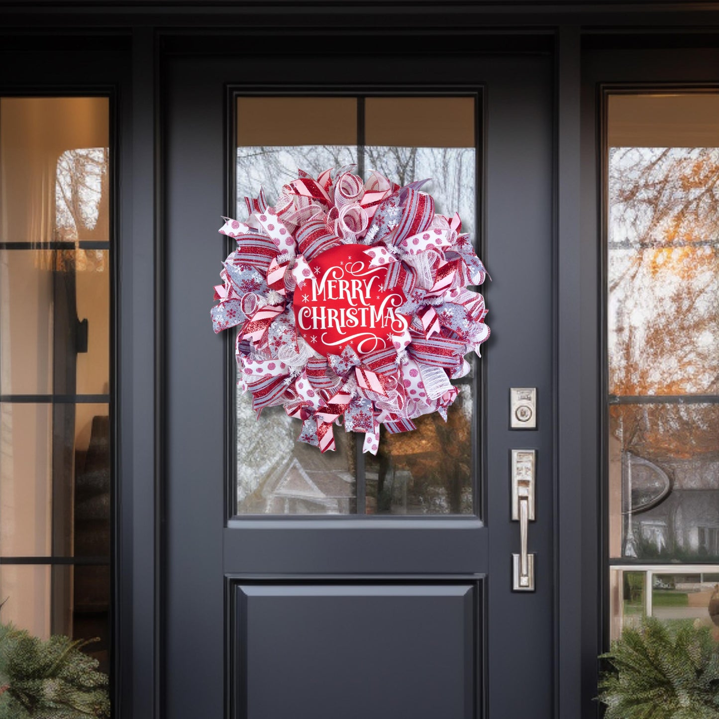 Large Christmas wreath with candy cane ribbon and Merry Christmas sign for front porch decor