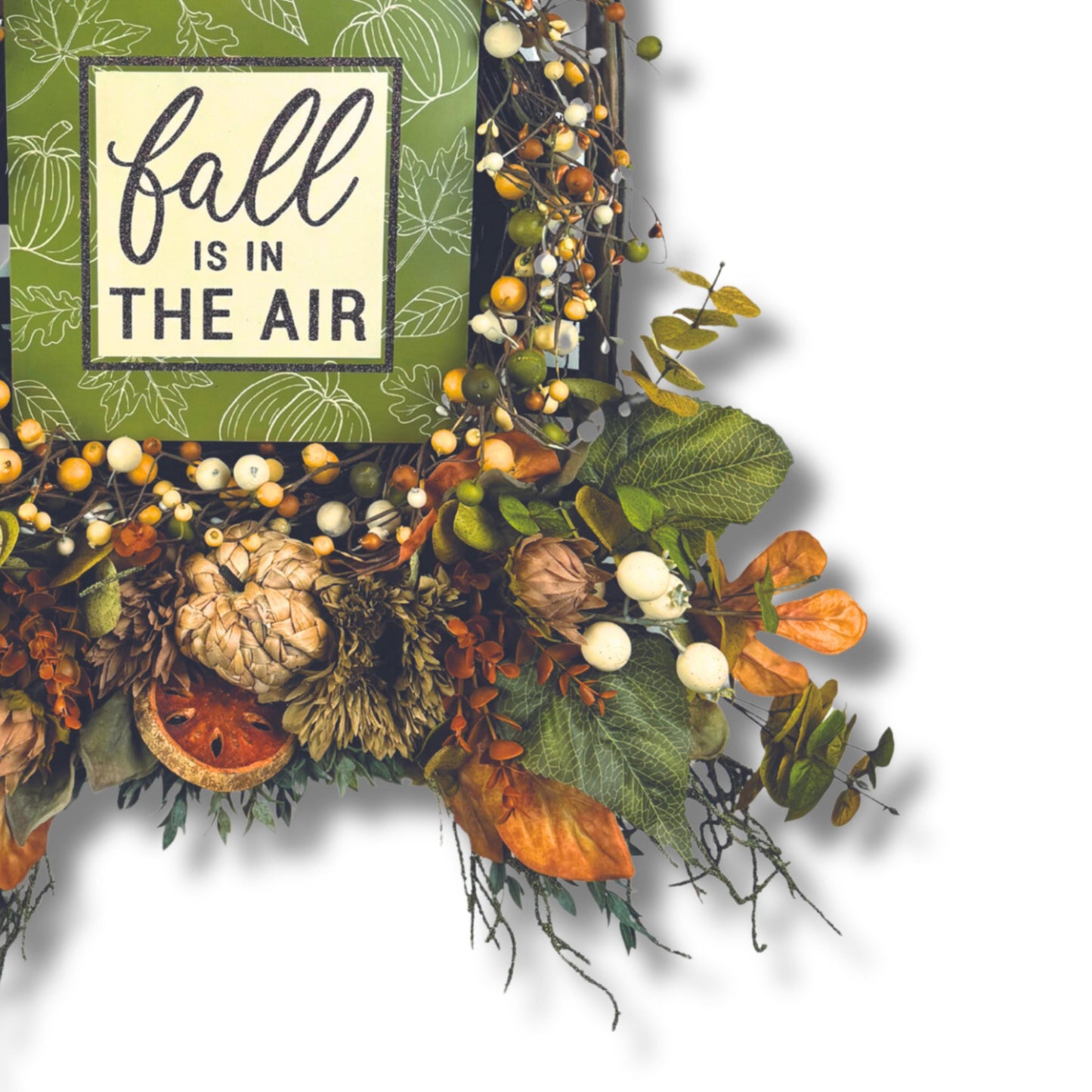 Faux pumpkin and cotton accents in rustic fall wreath with orange and green foliage