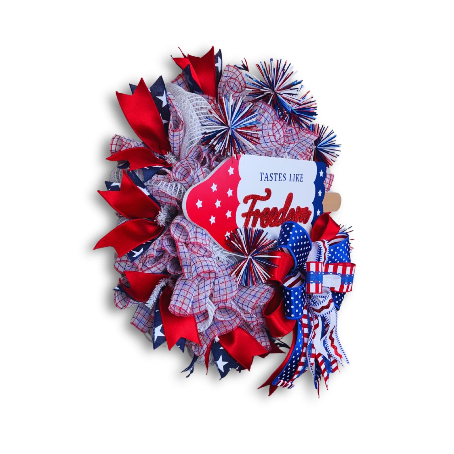 Side view of handmade patriotic popsicle wreath with glitter Freedom sign and red blue white mesh ribbons, perfect for Independence Day front door display