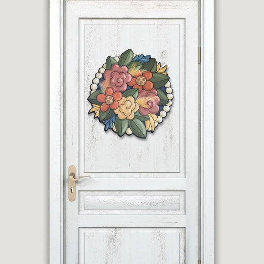 Elegant fall floral wreath door hanger displayed on a white door, featuring beaded accents and vibrant seasonal colors.