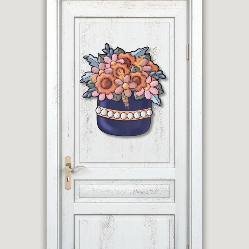 Navy basket floral door hanger displayed on a white door, featuring orange, pink, and blue flowers for fall-themed home decor.