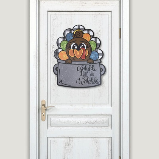 Turkey door hanger displayed on a white door, adding festive charm and humor to your Thanksgiving decor, ideal for entryways or porches.