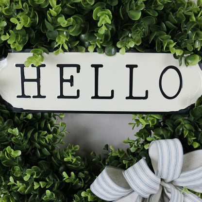 Vintage-style metal hello sign on farmhouse boxwood wreath, artificial greenery wreath for modern rustic home decor.