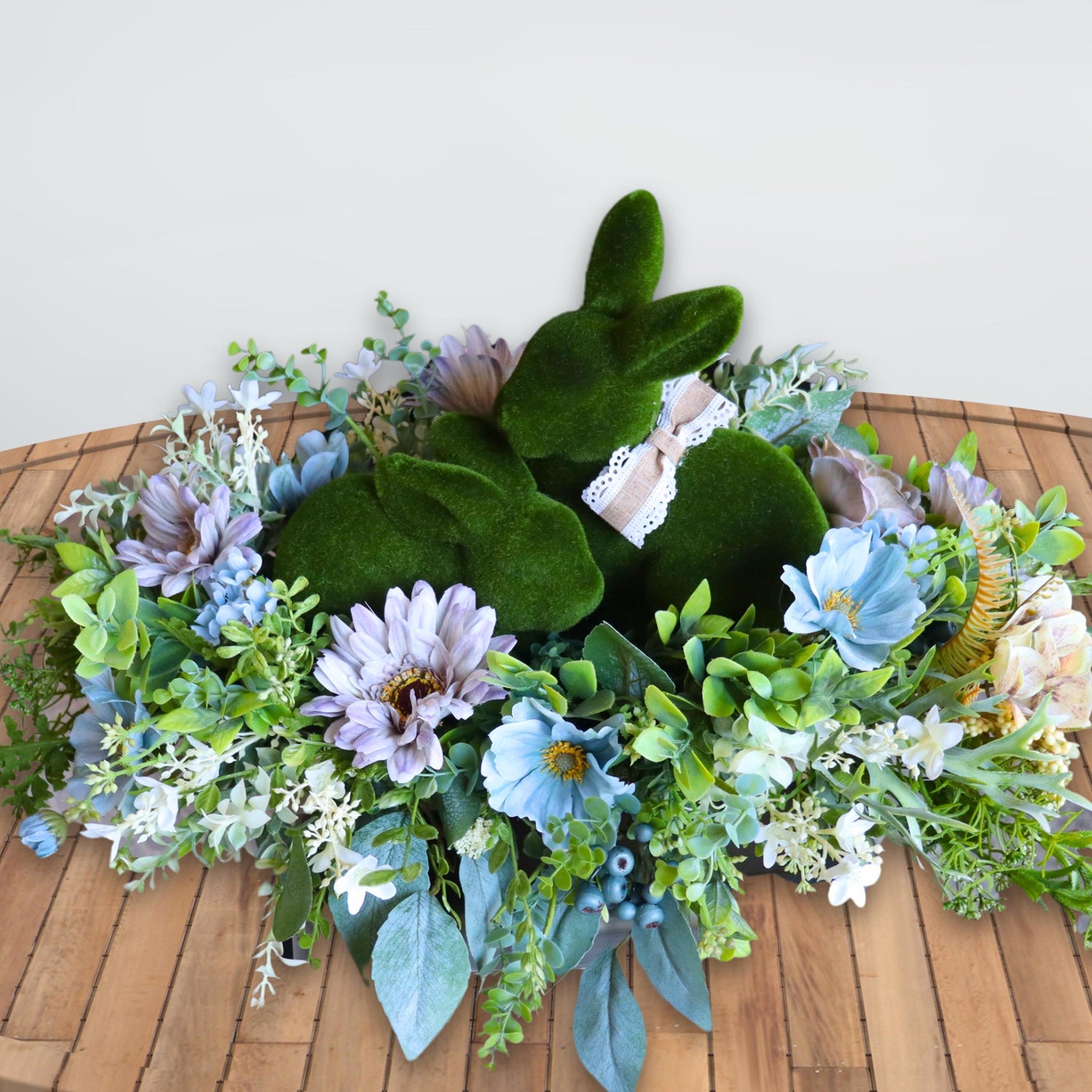 Easter bunny floral arrangement featuring realistic greenery and wildflowers, perfect for coffee table or entryway decor.