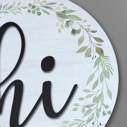 Detailed view of olive leaves, eucalyptus and delicate green botanicals on hi door sign wreath, showing high-quality UV printing
