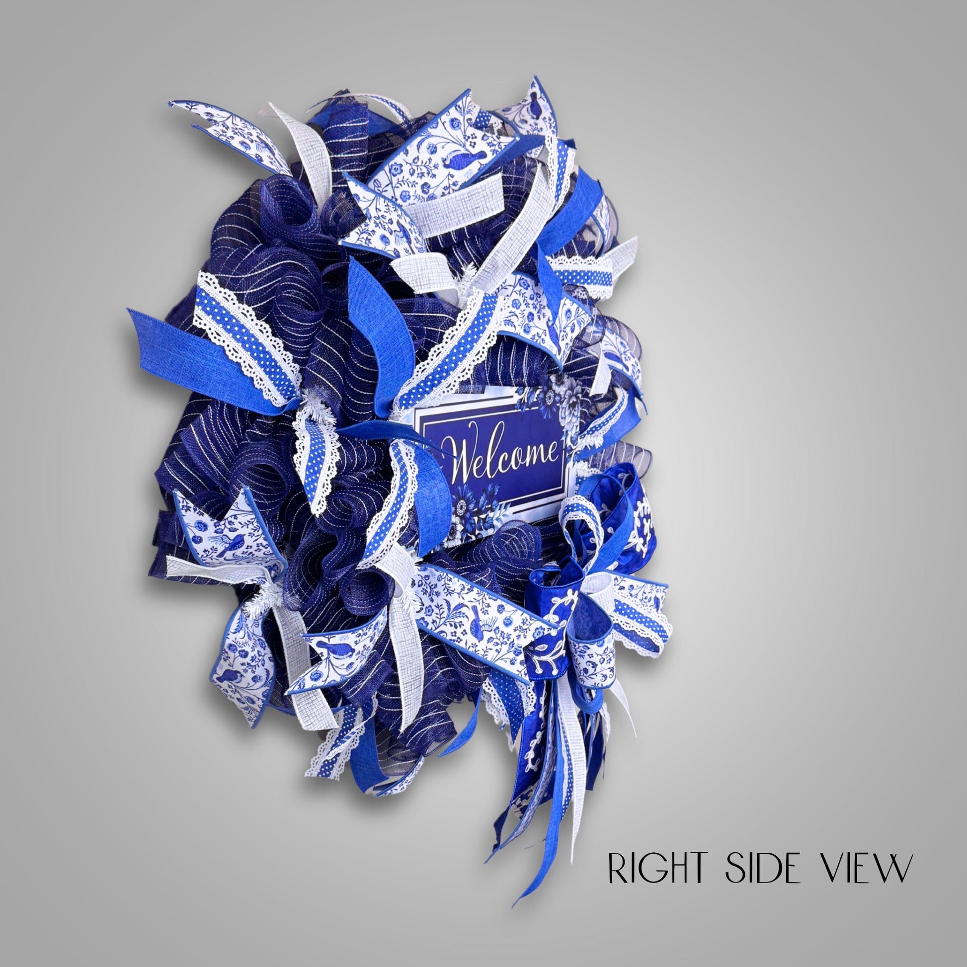 Right side view of handmade chinoiserie wreath with detailed ribbon textures and mesh base, ideal for year-round front door display.