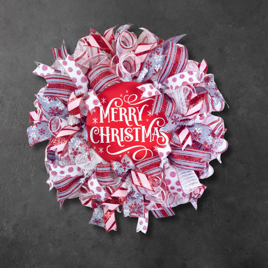 Handmade red and white Merry Christmas wreath with glitter ribbon for front door holiday decor