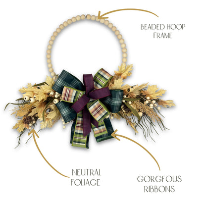 Handmade fall beaded hoop wreath with plaid bow and autumn leaves, displayed on a clean white background for product clarity.