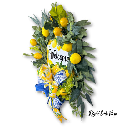 Right side view of lemon welcome wreath showing depth, 3D shape, and layered ribbon bow with faux citrus greenery