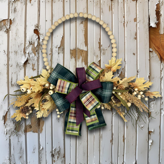Overhead view of beaded hoop wreath showing all design elements including plaid bow, faux wheat, berries, and maple leaves.