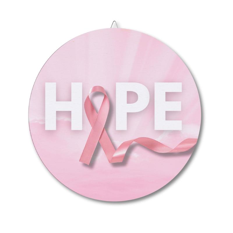 Circular wall decor sign featuring a pink ribbon and the word HOPE for breast cancer awareness