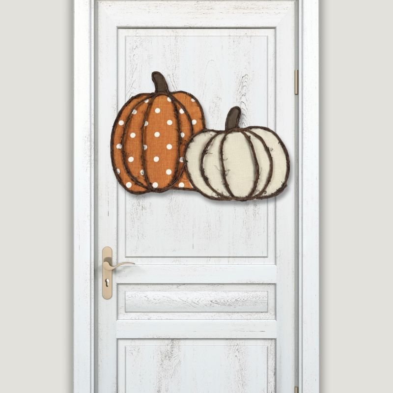 Rustic Pumpkin Door Hanger displayed on a white door. Lightweight and stylish, perfect for enhancing your front door or wall with seasonal charm.