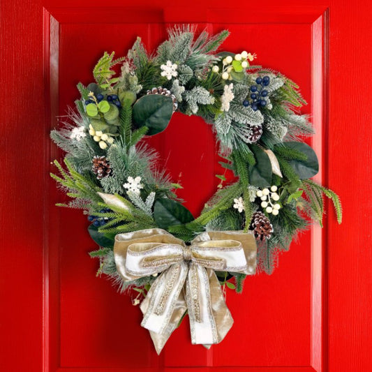 Rustic winter wreath with realistic greenery, pinecones, and berries hanging on a red door, ideal for seasonal holiday decor.