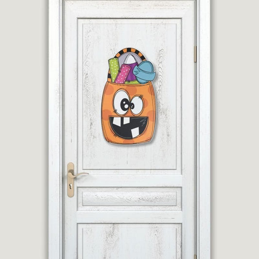 Halloween Smiling Candy Bag Door Hanger displayed on a white door, showcasing its colorful and fun design for indoor or outdoor use.