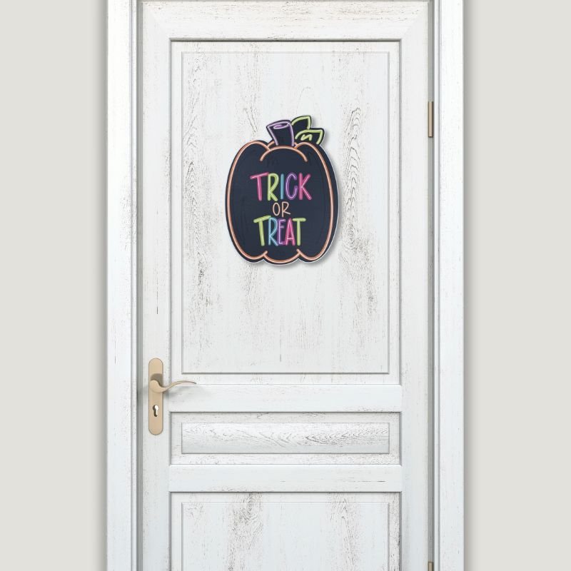 Trick or Treat Halloween Pumpkin Door Hanger displayed on a white front door, showcasing its vibrant design for Halloween decorations.